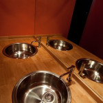 bathroom - 2 stainless steel sinks set into wooden board